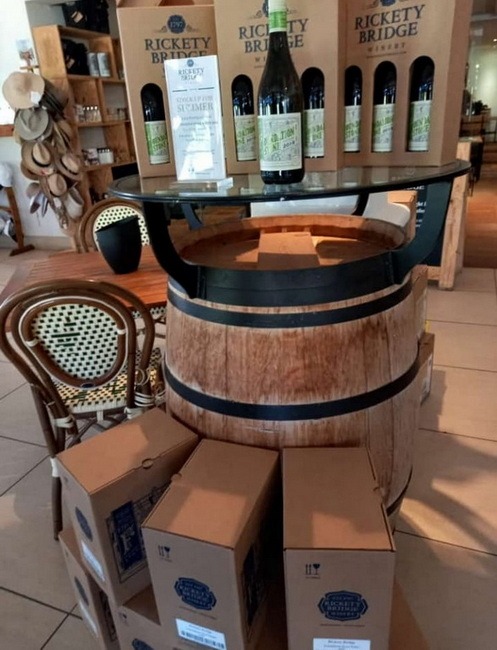 A picture of a wine barrel and boxes of wine