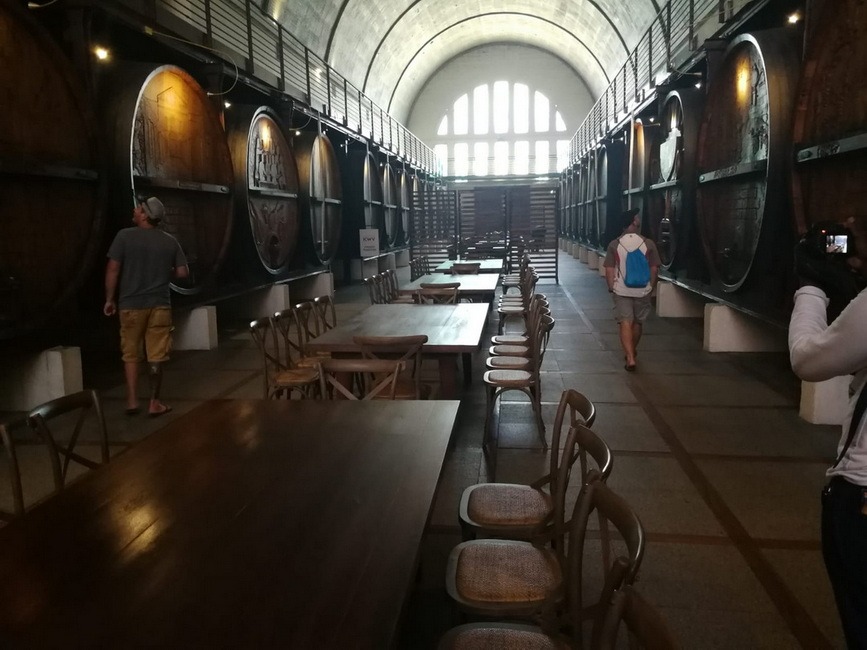 A picture of big wine barrels in a wine cellar