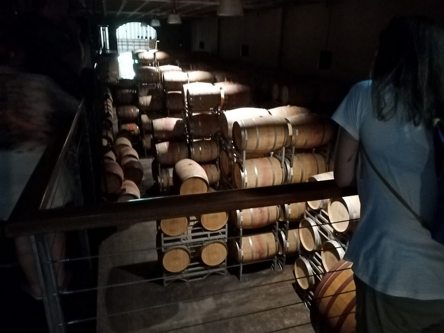 A picture of wine barrels in a cellar